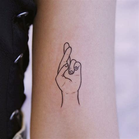 Crossed fingers tattoo - Tattoogrid.net