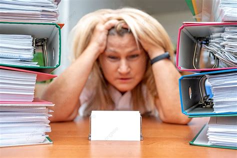 Stressed Admin Worker Amid Paperwork With Business Card Mockup Photo ...