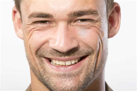 Portrait of young man, smiling, close up stock photo