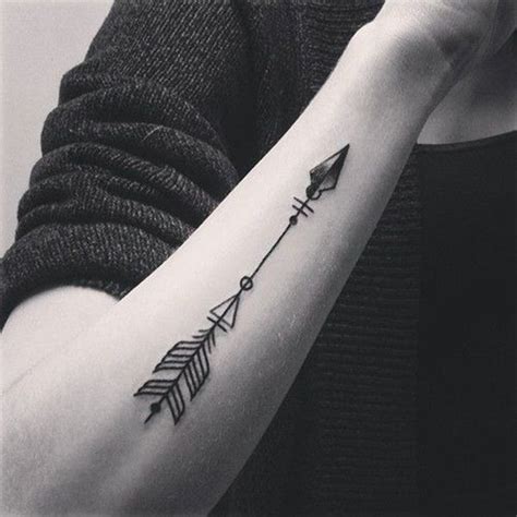 a woman's arm with an arrow tattoo on it