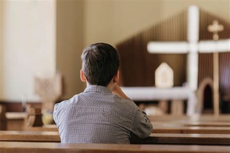 Free Photo | Back view young boy praying in the church