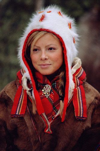 Portrait of pretty Sami girl in a traditional hat and peske at the Jokkmokk Winter Market ...