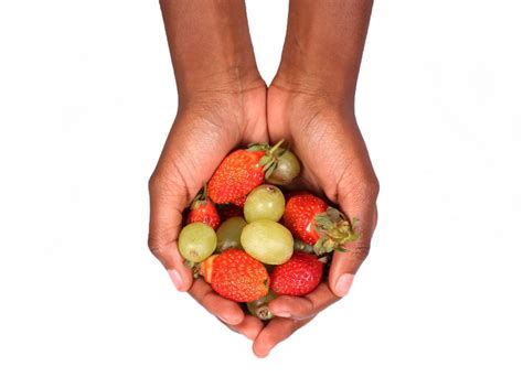 Hands Holding Strawberries and Green Grapes