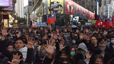 Thousands march as Hong Kong protests near half-year mark