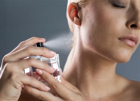 Close Up Of A Woman Spraying Perfume On Her Neck Stock Photo - Download ...