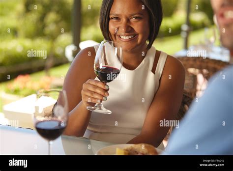 Sitting celebration food and drink holding wine glass drinking hi-res stock photography and ...
