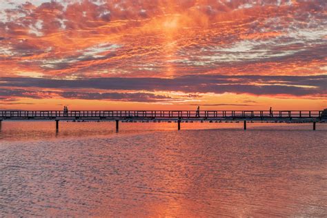 Silhouette of Bridge on Sea during Sunset · Free Stock Photo