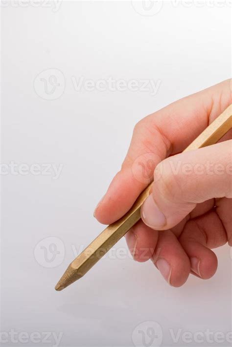 Hand holding a gold color pencil in hand 14508334 Stock Photo at Vecteezy