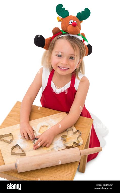 Festive little girl making cookies Stock Photo - Alamy