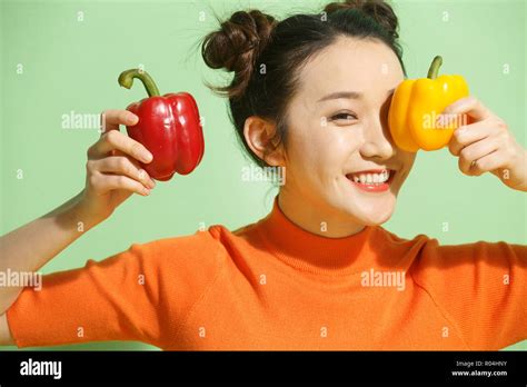 Young women with chili peppers Stock Photo - Alamy