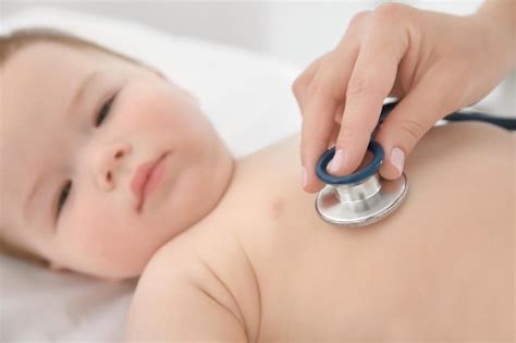 Premium Photo | Doctor examining little baby with stethoscope in clinic closeup baby health concept