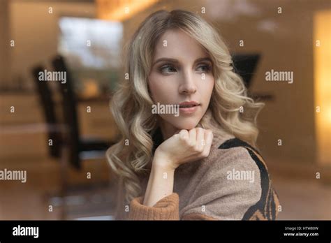 Portrait of a blond woman in the dining room Stock Photo - Alamy