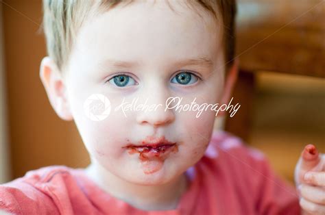 Little boy eating chocolate covered strawberries - Kelleher Photography Store