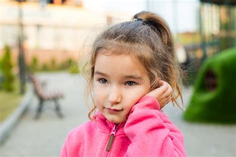 A Little Girl with a Sad and Frightened Face Holds Her Cheek with Her Hand - a Tooth Hurts. Ear ...