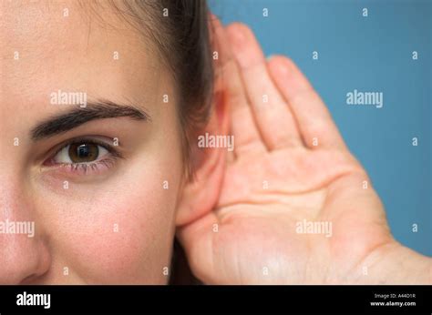 Young woman cupping hand ear hi-res stock photography and images - Alamy