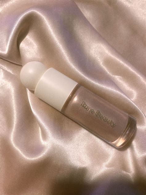 rare beauty liquid highlighter in shade enchant on a pink silk background Highlighter Swatches ...