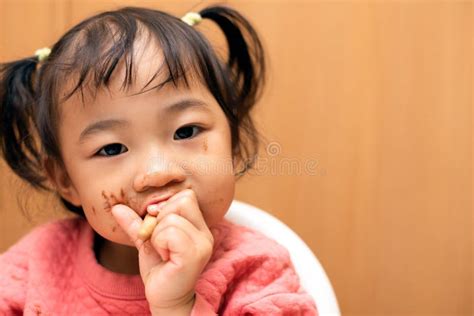 A Toddler or a Child Eating Chocolate Ice Cream in a Cone with a Messy Face Stock Photo - Image ...