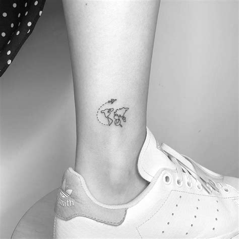 Small world map tattoo on the ankle.