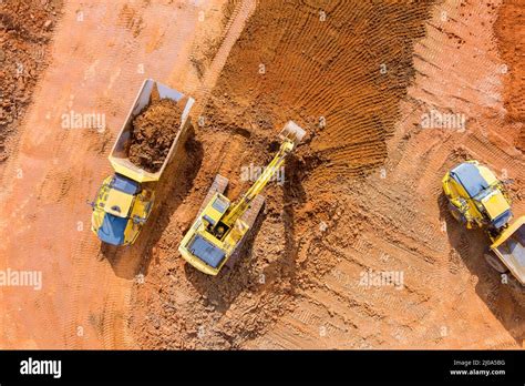 Backhoe working by digging soil at bucket teeth of backhoe digging soil ...