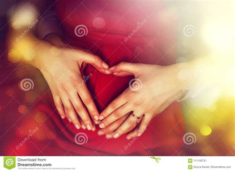 Pregnancy and Family Love Concept. Expecting Parents Holding Heart Shape Hands Stock Image ...