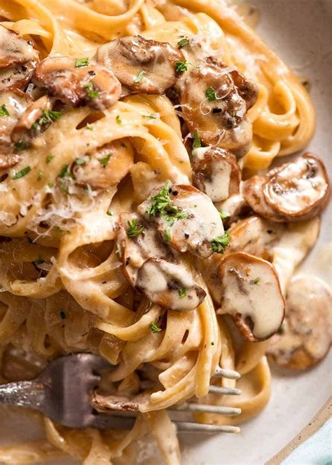 Close ups of Creamy Mushroom Pasta on a rustic handmade plate, ready to be eaten # ...