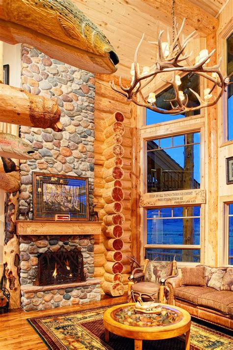 Photo of stone fireplace and living room inside a log home Home ...