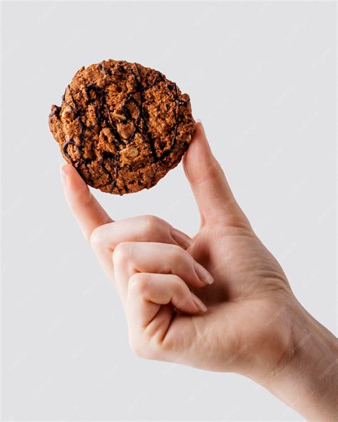 Free Photo | Close up hand holding delicious cookies