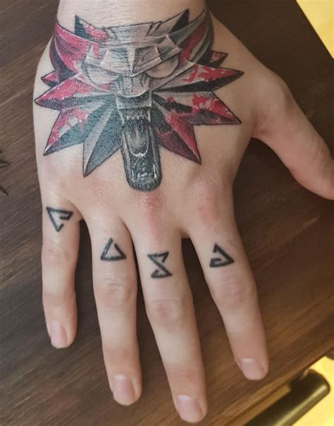 a person's hand with tattoos on it, and an arrow in the middle