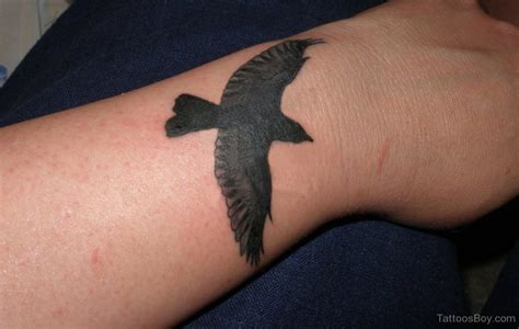 Black Bird Tattoo On Wrist | Tattoo Designs, Tattoo Pictures