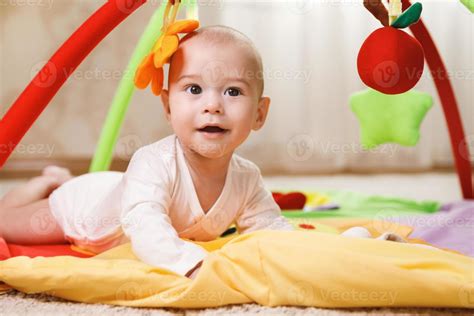 Cute baby is playing on the activity mat 14395717 Stock Photo at Vecteezy