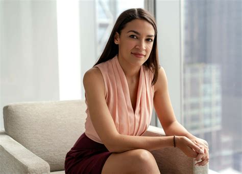 Download Alexandria Ocasio-cortez Sitting Down Desktop Wallpaper | Wallpapers.com