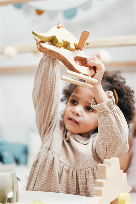 Girl Holding Wooden Toys · Free Stock Photo