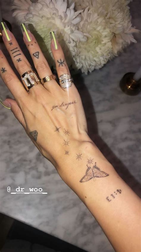 a woman's hand with some tattoos on it