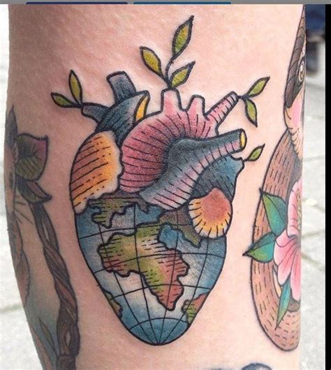 Colored heart with earth tattoo on arm