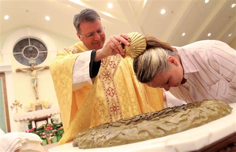 Father Greg baptizing catechumen Susan Zabiela for Easter http://www ...