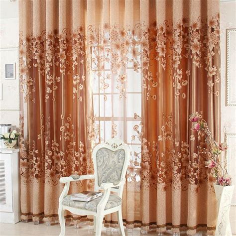 a chair sitting in front of a window covered in curtains