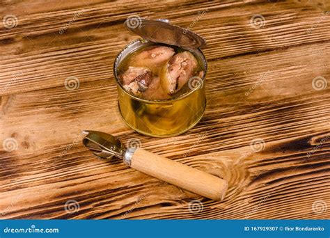 Can Opener and Tin Can with Sardine on Wooden Table Stock Image - Image ...