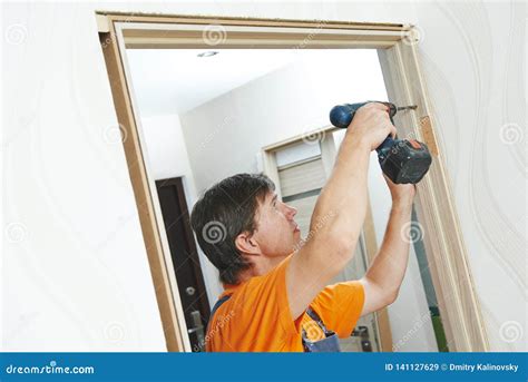 Door Frame Installation. Carpenter Works with Drill Stock Image - Image of male, door: 141127629