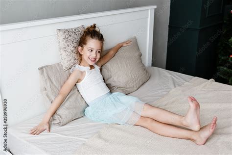 little cute girl is lying on the bed Stock Photo | Adobe Stock