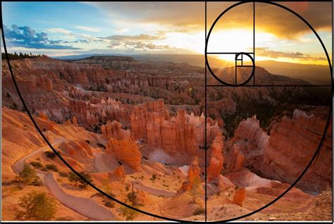 an image of the sun setting over hoodoos and canyons in the distance