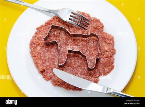 Meat with Ausstecher in horse form, symbolic photo horse meat-scandal Stock Photo - Alamy