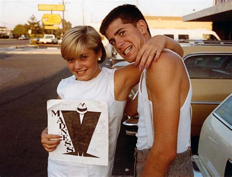 Gwen Stefani with her brother Eric, holding an autographed sign of their favorite band, "Madness ...