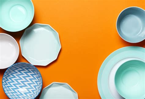 Premium Photo | Set of different modern white and blue plates, bowls and cups on pink and blue.