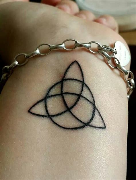 Triquetra tattoo on wrist | Knot tattoo, Finger tattoos, Ancient ...