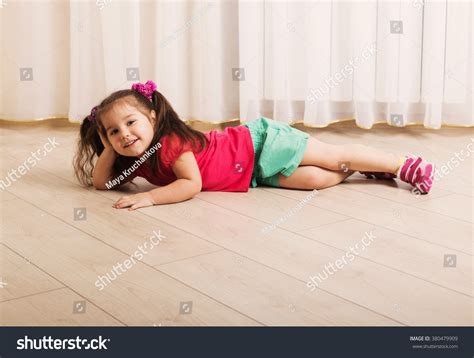 Happy Little Girl Lying On Floor Stock Photo 380479909 : Shutterstock