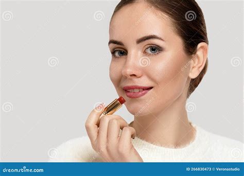 Close Up Portrait of Attractive Girl Rouging Her Lips. Woman Holding Red Lipstick. Stock Image ...