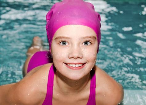 Portrait of Cute Smiling Little Girl Child Swimmer in Pink Swimming Suit and Cap in the Swimming ...