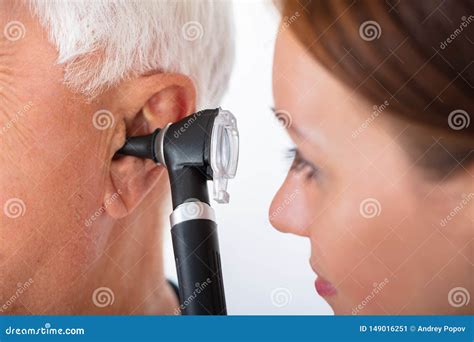 Doctor Examining Patient`s Ear with Otoscope Stock Image - Image of ...