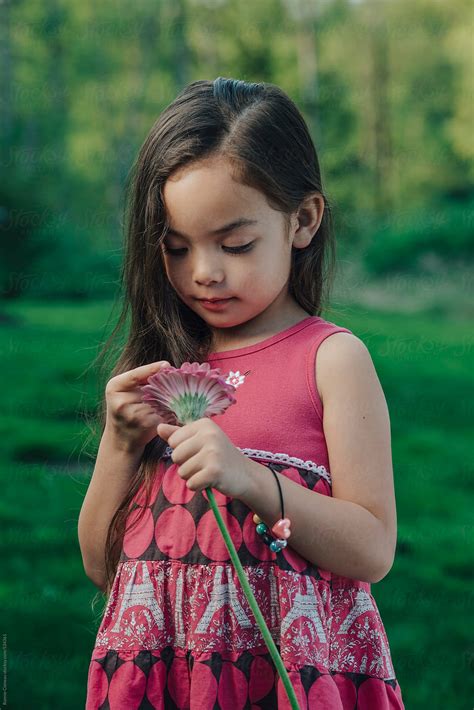 "Little Girl Holding Flower" by Stocksy Contributor "Ronnie Comeau ...