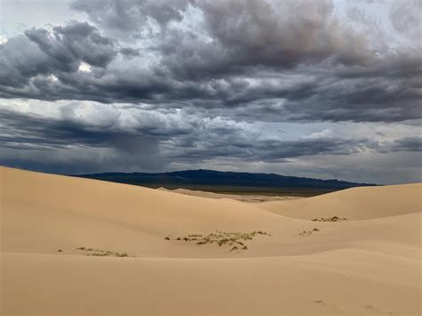 Rain clouds over the Gobi desert bringing rain to the mountains : r/raining